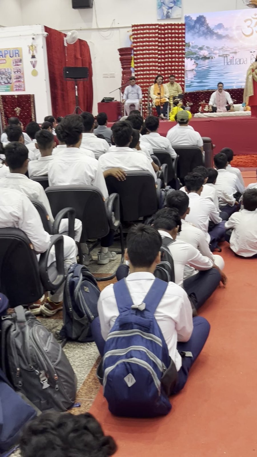 Students of Sarvodaya Bal Vidyalay seated before the Naitrana Foundation stage