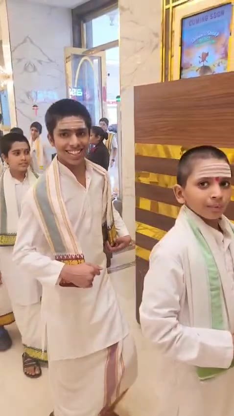 Gurukul students in traditional white dress entering PVR Cinemas