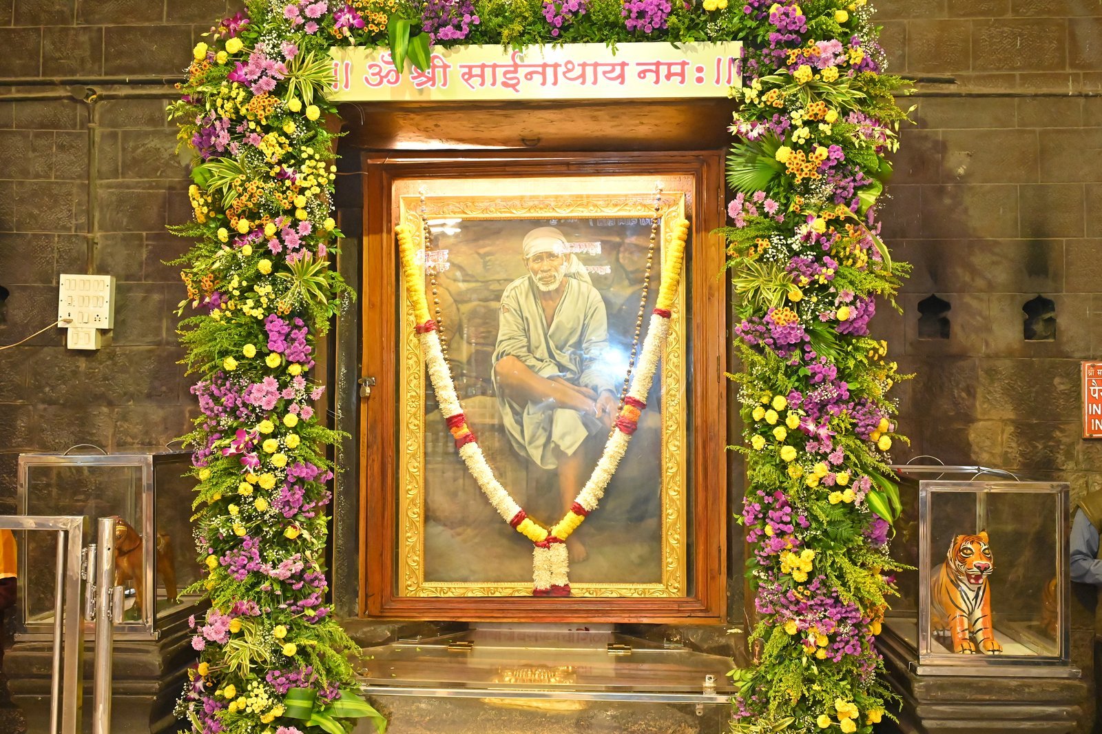 Sai Baba portrait framed with fresh flowers