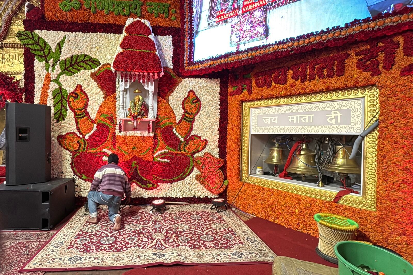 Jai Mata Di bells and floral Ganesh wall at the Vaishno Devi bhavan